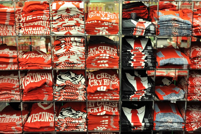 folded shirts with university of wisconsin logos  stacked up on shelves